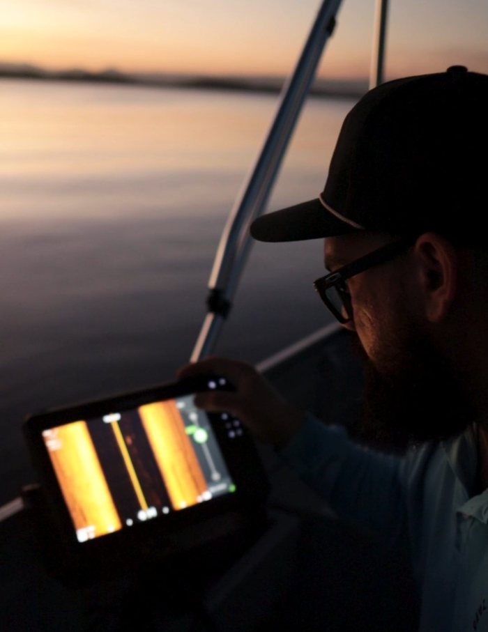 Skipper reading a sounder screen at last light